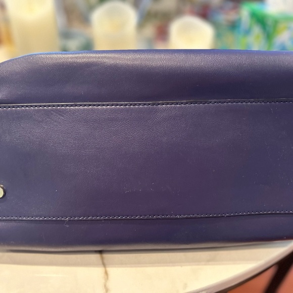 It’s a BCBG Maxazria bag with a lock.The color is bluish violet. - Picture 3 of 3